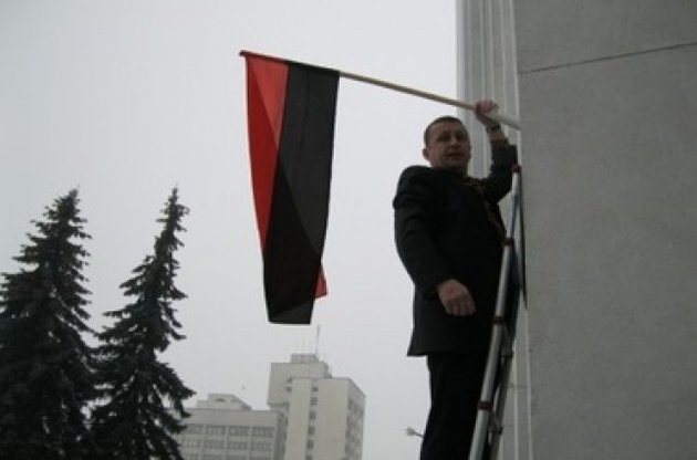 Володимир Стаюра вішає прапор на будівлю облради