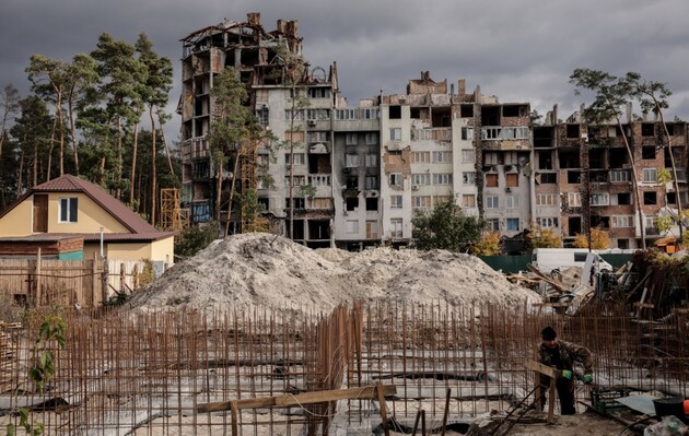 Робітники будують нові будинки на місці зруйнованої під час бойових дій у березні 2022 року будівлі в місті Ірпінь, 23 жовтня 2023 року