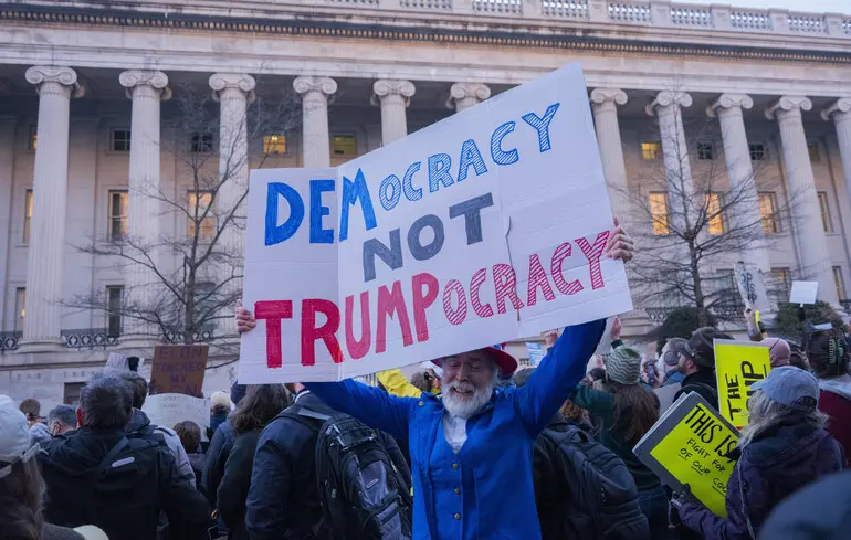 Протестующий во время митинга перед Министерством финансов США в Вашингтоне 4 февраля 2025 года