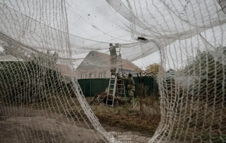 Воины зенитно-ракетного артиллерийского дивизиона 24 ОМБр имени короля Даниила натягивают защитные сетки от вражеских FPV-дронов на улицах Константиновки