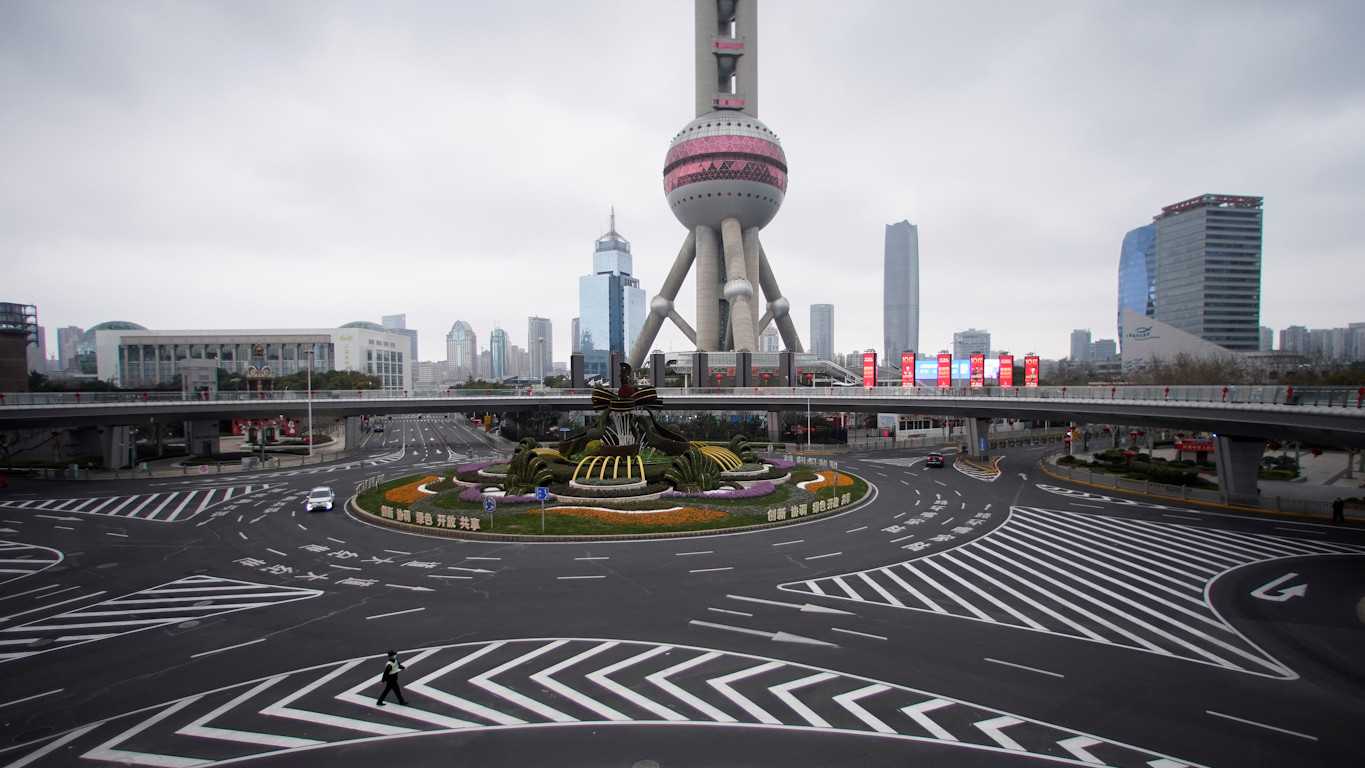 Патрульный в маске возле башни "Восточной жемчужины" в Шанхае