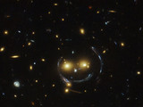 В центрі знімка дві галактики нагадують смайлик. Фото з телескопа Хаббл